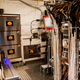 The MoEDAL experiment includes the blue light and the plastic sheets on the wall. The LHC’s collision point is on the right. Photo: Ryan F. Mandelbaum/Gizmodo.